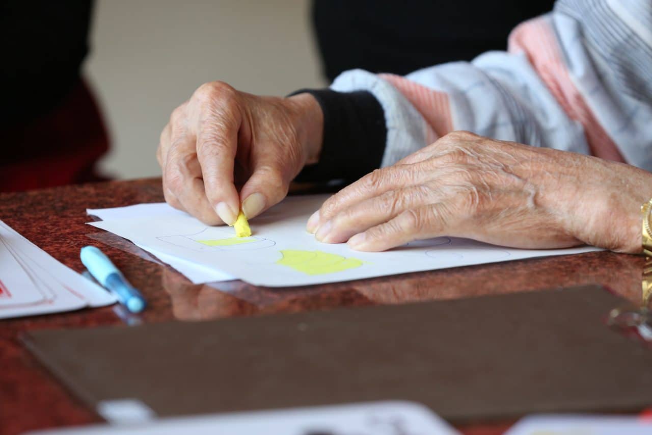 Close up of an older person's hands while coloring.