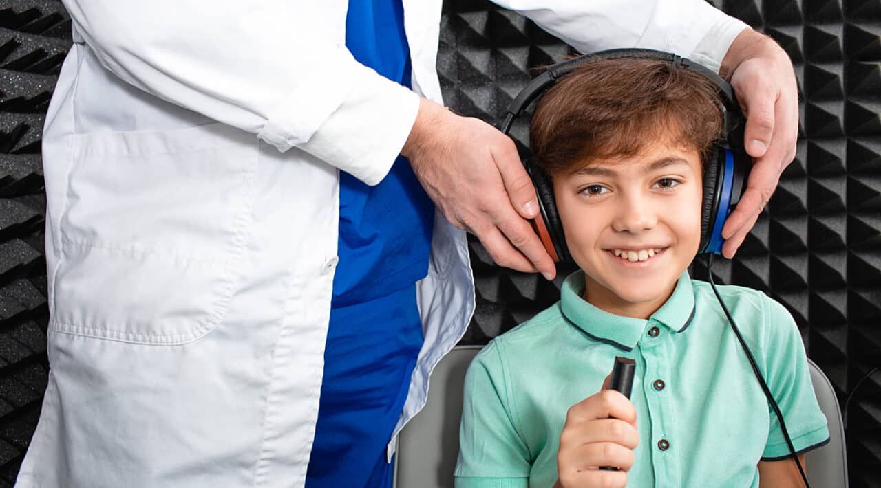 Young boy getting ready for his hearing test.