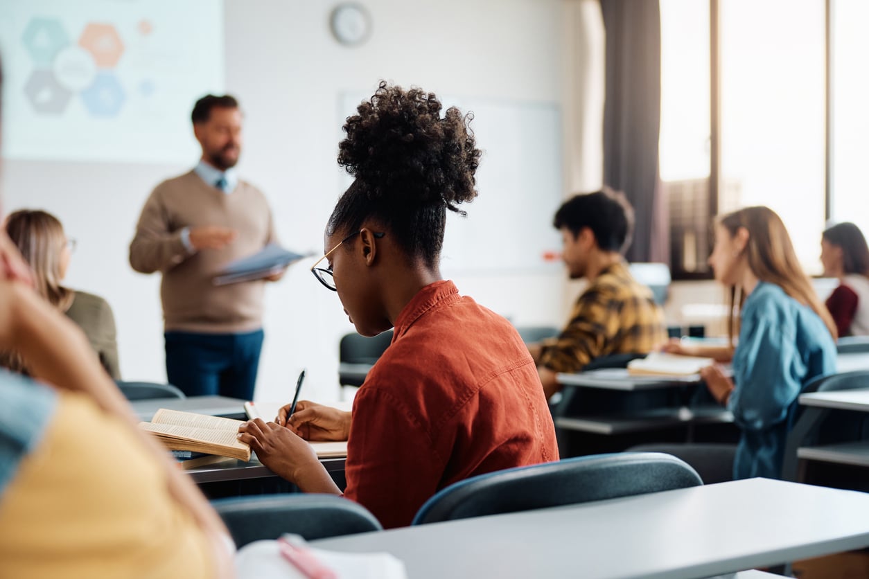 Student taking notes in class