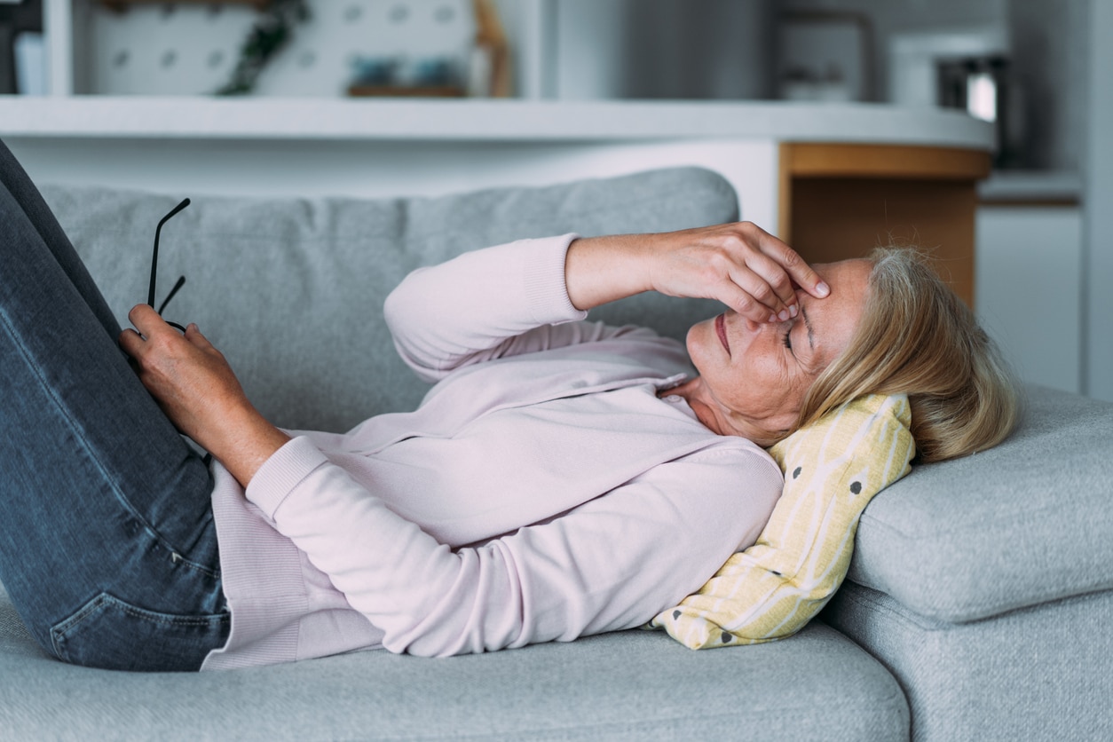 Exhausted woman holding her nose bridge