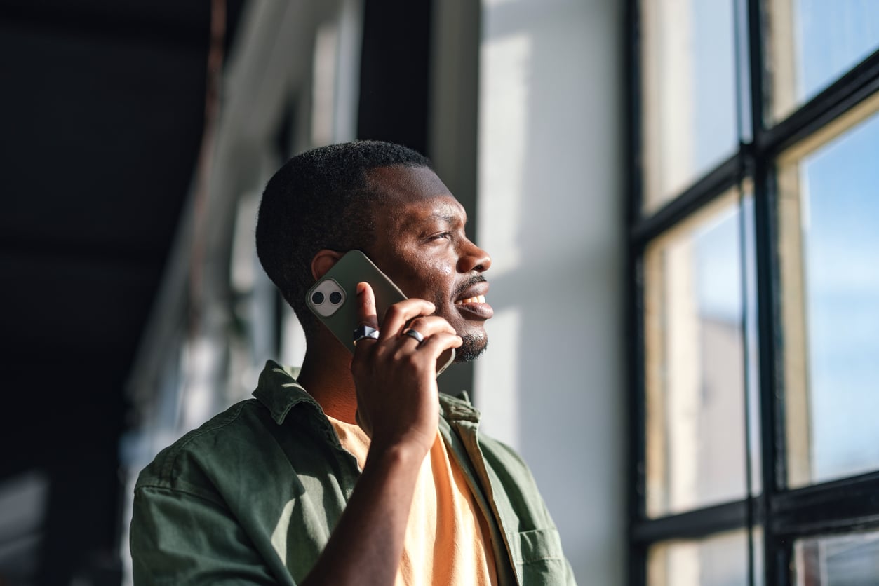 Man talking on the phone looking out the window