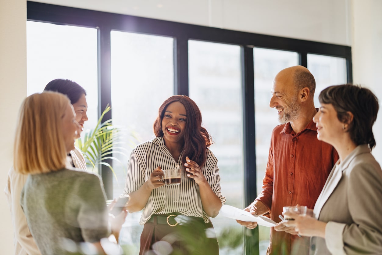 Team Engages in a Friendly Business Discussion in Modern Office Setting